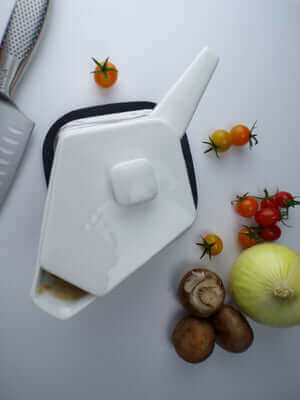 "HeatTHAT! Gravy insulated gravy boat with fresh vegetables on a white background"