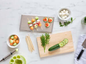 ChillTHAT! Platter with fresh appetizers, showcasing refreezable serving functionality for keeping food chilled and fresh.