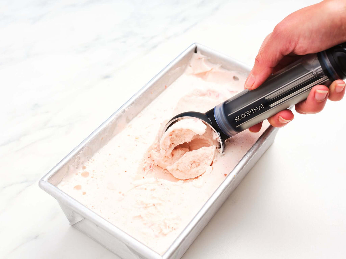 Ice cream being scooped with the ScoopTHAT! Radii Thermo Ring Ice Cream Scoop showing its efficiency and design.