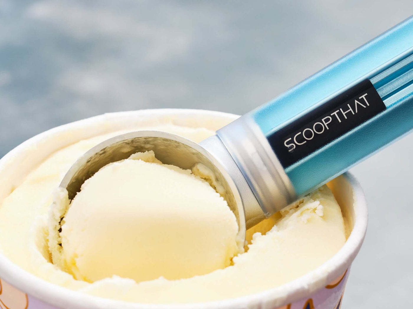 ScoopTHAT! Radii ice cream scoop in action with creamy vanilla, featuring advanced thermo ring technology for perfect scoops.