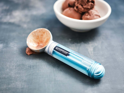 ScoopTHAT! Radii thermo ring ice cream scoop beside a bowl of chocolate ice cream, showcasing its innovative design.