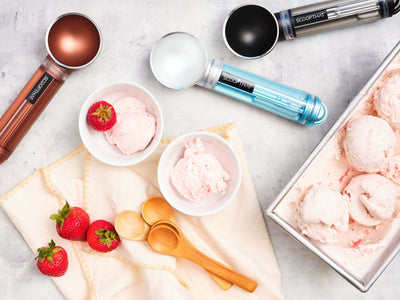 ScoopTHAT! Radii ice cream scoops with strawberry ice cream and wooden spoons on a napkin, showcasing vibrant design and functionality.